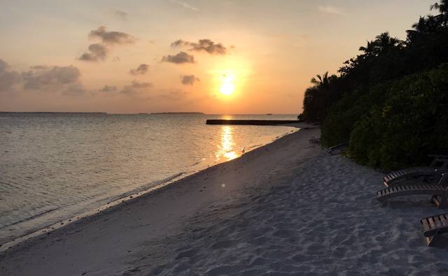 A yellow sunset in Makunudu in the Maldives.